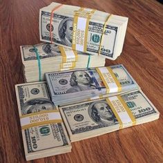 stacks of money sitting on top of a wooden table