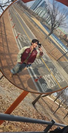 a man taking a selfie in the side mirror of a vehicle's rear view mirror