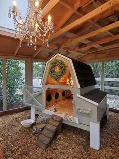 a chicken coop with a chandelier hanging from the ceiling