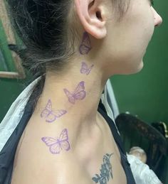 a woman with purple butterflies on her neck