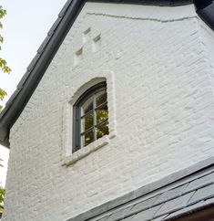 a white brick building with an open window