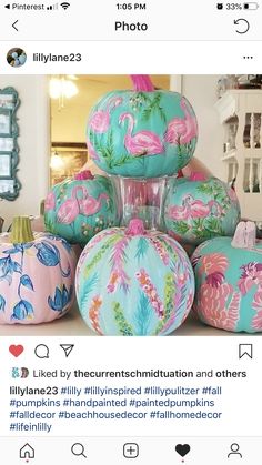 a bunch of painted pumpkins sitting on top of each other in front of a mirror