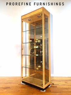 a wooden and glass display case sitting on top of a hard wood floor