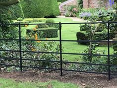 a garden with hedges and bushes surrounding it