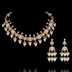 Add an inimitable touch of glamour and panache to your ensemble in our Alyssa Set! Glamorous set encrusted with handset kundan and CZ stones along with dangling beads. The set includes a necklace and a pair of earrings. Approximate earrings length is 2" Gold-plated on high-quality brass as base metal. Made by order. Kindly allow 5-7 weeks for the delivery of this item. For custom or urgent requests, please contact support@alacouture.com. *Please Note: We use faux stones and beads in all of our j