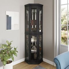 a tall black corner cabinet with glass doors in a living room next to a blue chair