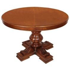 a round wooden table with four pedestals on each side and one end at the top