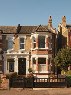 a large brick house with white trim around the windows