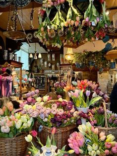 baskets filled with flowers are hanging from the ceiling