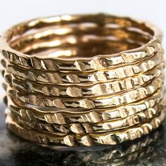 Our Coin-Edge Hammered Yellow Gold-filled stacking ring is entirely hand-made & mixes well with most of the items in our store. YOU WILL RECEIVE: * Seven 16g Coin Edge hammered Yellow Gold-filled rings 7 rings total! * Made with: 16g (1.29 mm) 12k Yellow Gold-filled wire. * When stacked, they measure at just over half an inch. * We do make 1/2 & 1/4 sizes, just leave a note with your size preference. * All of our items are entirely hand crafted and have a standard processing time of 3-5 Stacked Rings In 14k Gold As Gift, Stacked 14k Gold Rings For Gift, Stacked 14k Gold Rings As Gift, Handmade 14k Gold Stackable Rings, Handmade Yellow Gold Stackable Rings For Promise, Handmade Yellow Gold Stackable Promise Rings, Stackable Bands In Recycled Gold, Stacked Round Rings As Gift, Stacked Round Rings For Anniversary