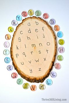 a tree slice with letters and numbers on the inside, surrounded by cut out magnets