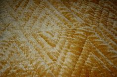 an orange and white textured bed spread