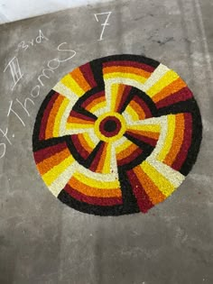 a colorful design on the ground with words written below it