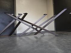 two metal sculptures sitting on top of each other in front of a door with black doors