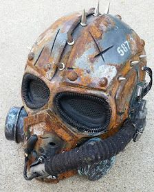 an old, rusty mask with spikes on it's head is laying on the ground