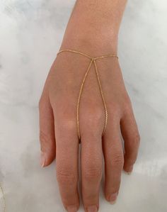 "DETAILS - Crafted with pure solid 14k gold - Finger loop is approximately 7.5\" - Bracelet is adjustable up to 7\" - Made in New York VARIATIONS If you require any variation of this style, feel free to message us. We will do our best to accommodate you. Additional costs may apply depending on the variation. POLICY This item is made to order. Made to order items are final sale and sometimes require additional production time. However, our goal is to give you something you love. If you have any q Adjustable Chain 14k Gold Bangle, 14k Gold Bangle Bracelet With Adjustable Chain, Adjustable Yellow Gold Bracelets 14k Gold Filled, Adjustable 14k Gold Bracelet, Tarnish Resistant, Adjustable 14k Gold Modern Jewelry, Adjustable Chain 14k Yellow Gold Bracelets, Adjustable 14k Gold Tarnish-resistant Bracelet, Formal Adjustable Gold Bracelet, Tarnish Resistant, Adjustable 14k Yellow Gold Filled Bracelets