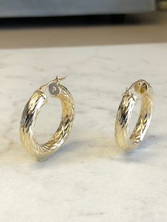 "14kt Yellow Gold ITALIAN Hoop Earrings that are very well-made with diamond cut rope design and uniform pattern throughout. These Italian Hoop Earrings are 1 1/4\" in diameter and are of hollow tubular 5.5mm thickness with a secure latch closure. These earrings have a brilliant shiny and sparkling finish and weigh 6.3 grams. This item would Retail for $945.00" Luxury Diamond Cut 14k Gold Hoop Earrings, Luxury 14k Gold Diamond Cut Hoop Earrings, Luxury 14k Gold Hoop Earrings With Diamond Cut, Cali Girl, Rope Design, Gold Hoop, Gold Hoop Earrings, Diamond Cut, Beautiful Earrings