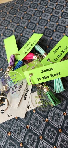 several key chains and tags on top of a bed