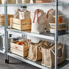 three shelves with bags and baskets on them