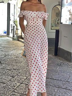 a woman in a white polka dot dress