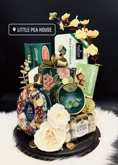 a basket filled with lots of assorted items on top of a white fur rug