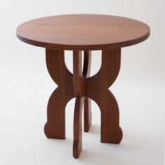 a round wooden table with two legs and a circular top, on a white background