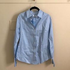 Never Worn, Nwot Ck Women’s Long Sleeve Button Down Light Blue Color Spring Calvin Klein Button-up Tops, Calvin Klein Spring Button-up Tops, Calvin Klein Button-up Tops For Spring, Calvin Klein Button-up Tops For Business Casual, Classic Calvin Klein Shirt With Button Closure, Blue Shirt With Back Button Closure For Work, Calvin Klein Spring Shirt With Button Closure, Spring Fitted Calvin Klein Shirt, Fitted Calvin Klein Shirt For Spring