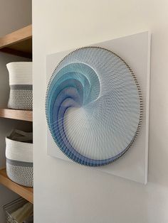 a blue plate sitting on top of a white wall next to shelves filled with baskets