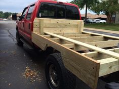 a red pick up truck parked in a parking lot