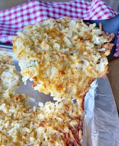 a close up of a piece of pizza on a pan with a spatula in it