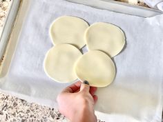 a person is making some food on a sheet of wax paper and it looks like they're ready to cook