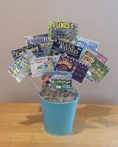 a blue bucket filled with magazines on top of a wooden table