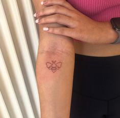 a woman with a small tattoo on her arm