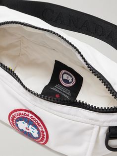 Whether you sport it around the waist or cross-body, Canada Goose's bag is a practical companion for every day. It's made from durable shell appliquéd with the label's signature logo patch and features front and back pockets for easy accessibility and reflective details that ensure visibility. Functional White Belt Bag For Travel, White Sporty Shoulder Bag For Outdoor, Sporty White Shoulder Bag For Outdoor, White Bag With Pouch For Outdoor Activities, White Bag With Removable Pouch For Outdoor Activities, Practical White Nylon Bags, Functional White Crossbody Belt Bag, Practical White Shoulder Bag For Outdoor Activities, Practical White Shoulder Bag For Outdoor