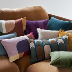 a couch with many pillows on top of it