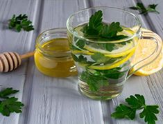 a glass mug filled with lemon and mint tea