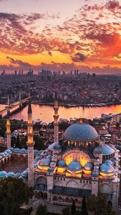 an aerial view of the blue mosque in turkey at sunset, with its lights on