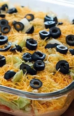 a casserole dish with black olives and cheese