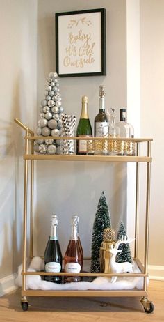 a bar cart filled with bottles of wine and christmas decorations