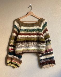 a colorful sweater hanging on a wall