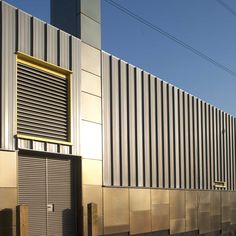 an industrial building with metal siding and shutters