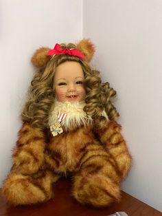 a teddy bear sitting on top of a wooden table