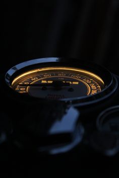 a close up of a clock in the dark