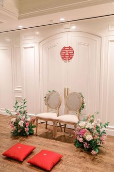 two chairs sitting next to each other on top of a hard wood floor covered in flowers