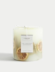 a candle with lemon slices on it