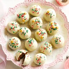 white chocolates with sprinkles on a pink plate