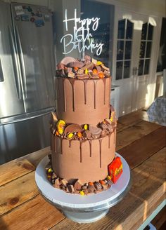 a three tiered cake sitting on top of a wooden table