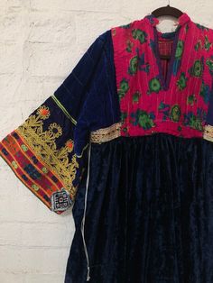 "A gorgeous, traditional Afghani Kutchi dress made by hand. Me asurements are 20\" across the chest. 48\" from mid shoulder to the bottom of the piece. 19 1/2\" long from shoulder to wrist." Folk Style Embroidered Transitional Dresses, Transitional Multicolor Embroidered Dresses, Transitional Season Embroidered Multicolor Dresses, Folk Style Embroidered Dress With Traditional Drape, Folk Style Dress With Embroidered Border For Festivals, Folk Dresses With Embroidered Border For Festivals, Traditional Dress With Embroidered Neckline For Festivals, Fitted Embroidered Dress With Traditional Multicolor Patterns, Folk Style Dress With Intricate Embroidery For Ceremonial Use