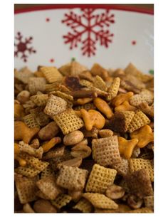 a bowl filled with chex mix on top of a wooden table