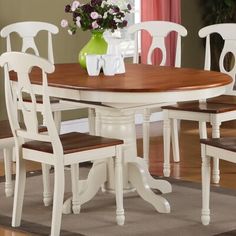 a dining room table with four chairs around it